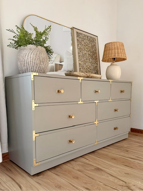 Gray dresser with gold accents 