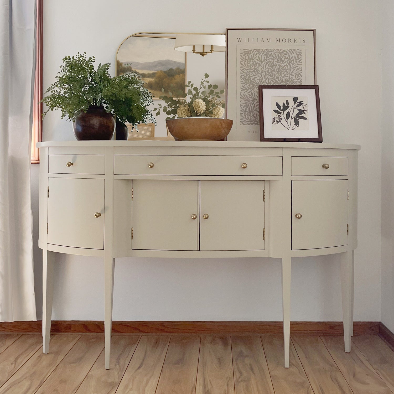 Refinished Hickory sideboard painted in Accessible Beige with champagne brass knobs and styled with neutral decor